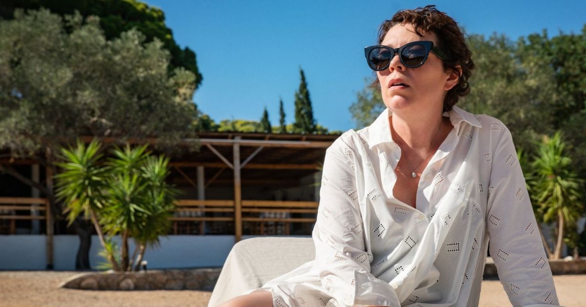 Olivia Colman on the beach with shades in The Lost Daughter