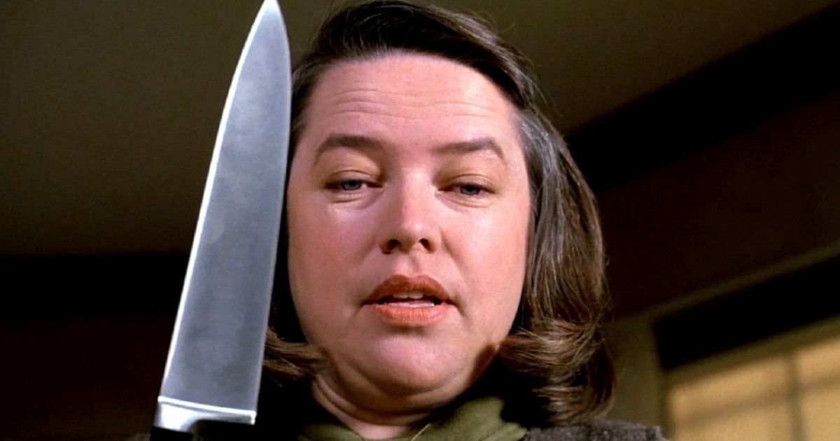 Kathy Bates holds a knife by her face in Misery
