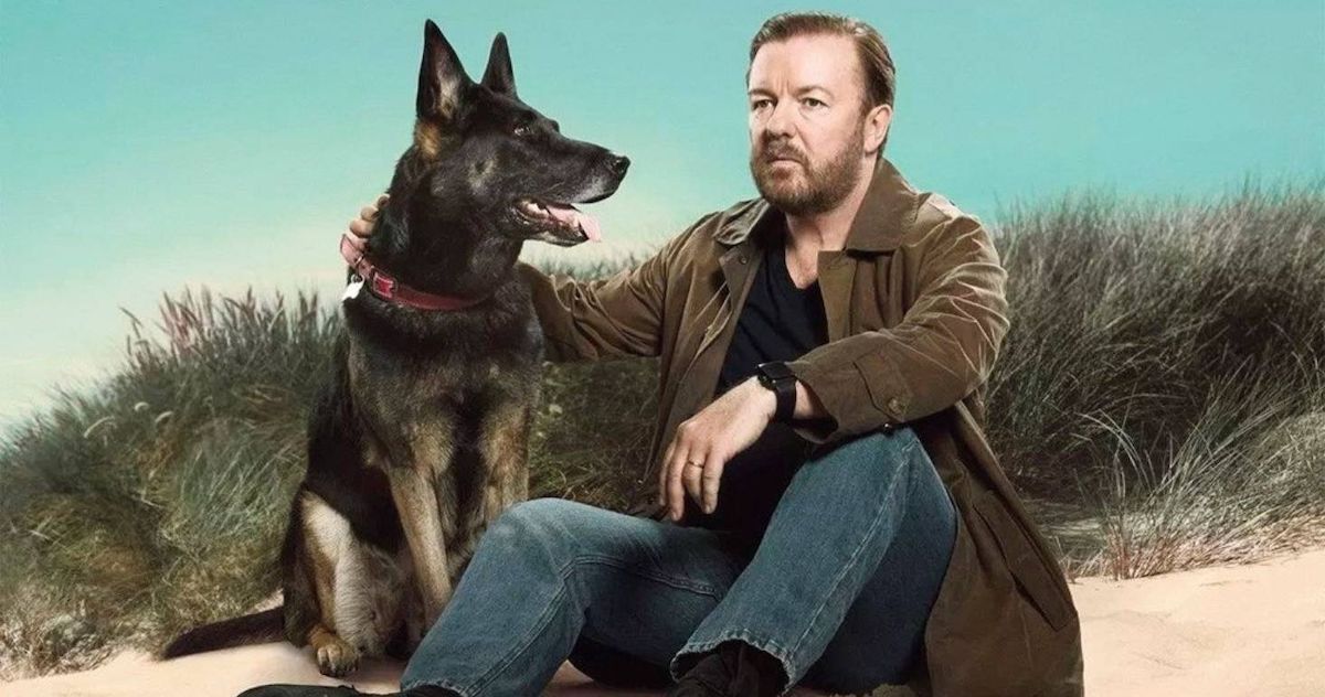 Ricky Gervais sits next to his dog in After Life