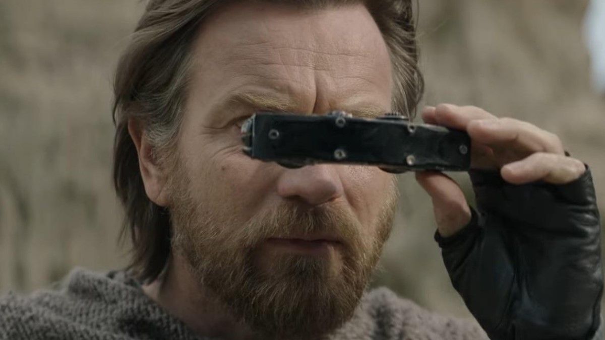 Obi-Wan Kenobi holds binoculars up to his eyes in a close-up