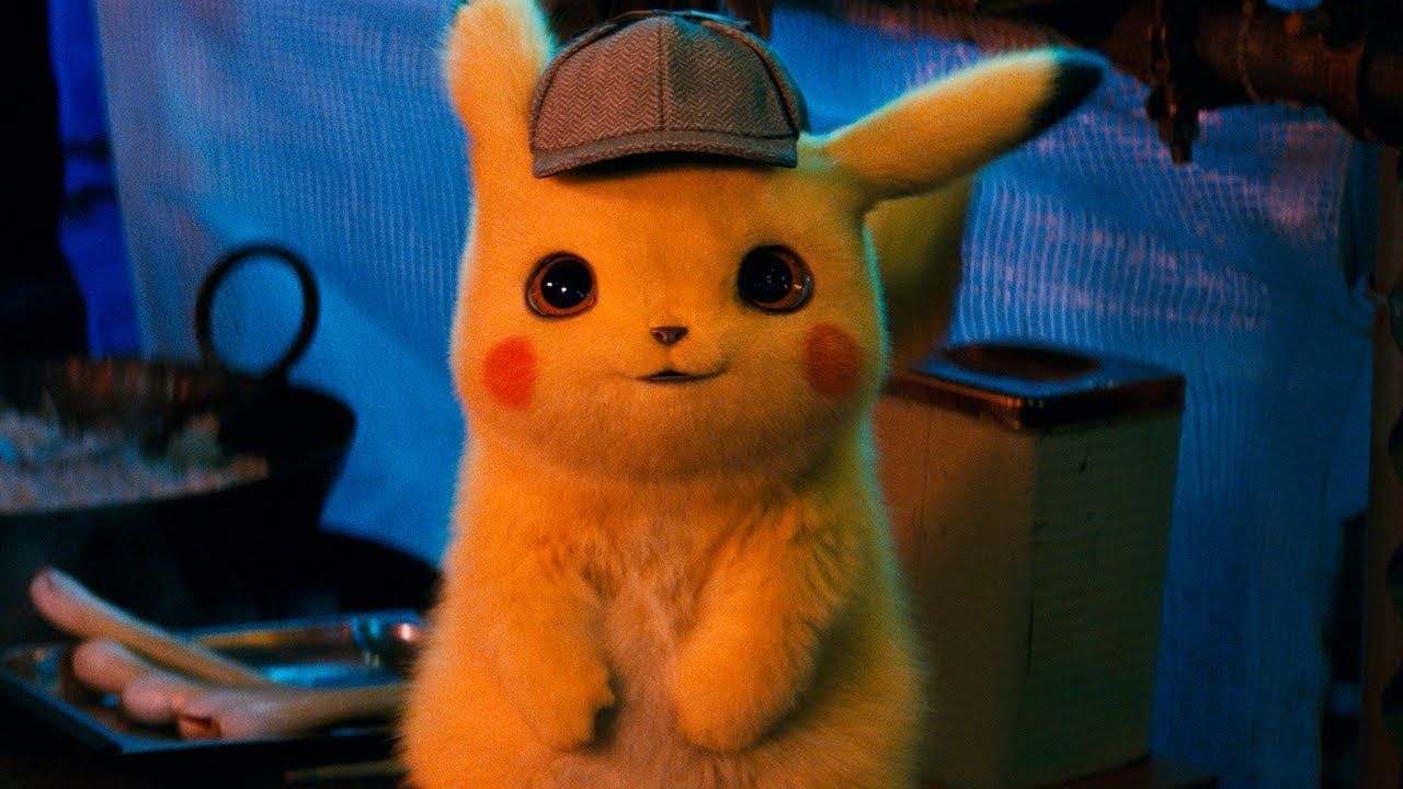 A pikachu in a detective hat smiling up at the camera.