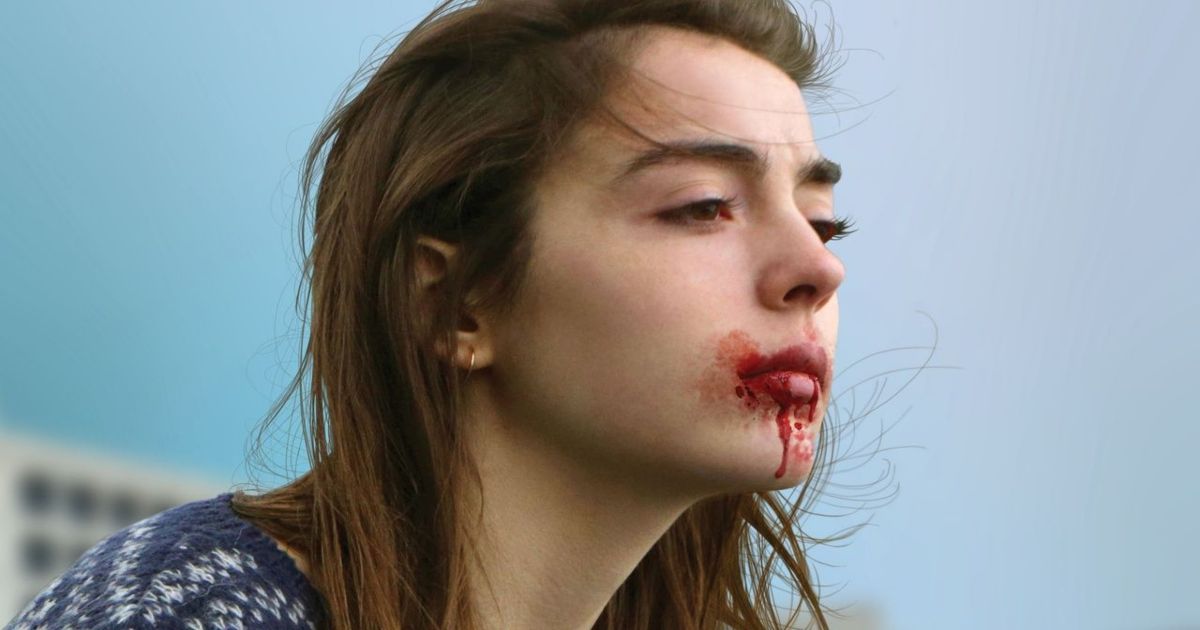 A woman with a bloody mouth in Raw