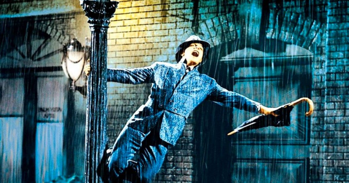 A estrela de Singin in the Rain, Gene Kelly, balança em um poste de luz na chuva