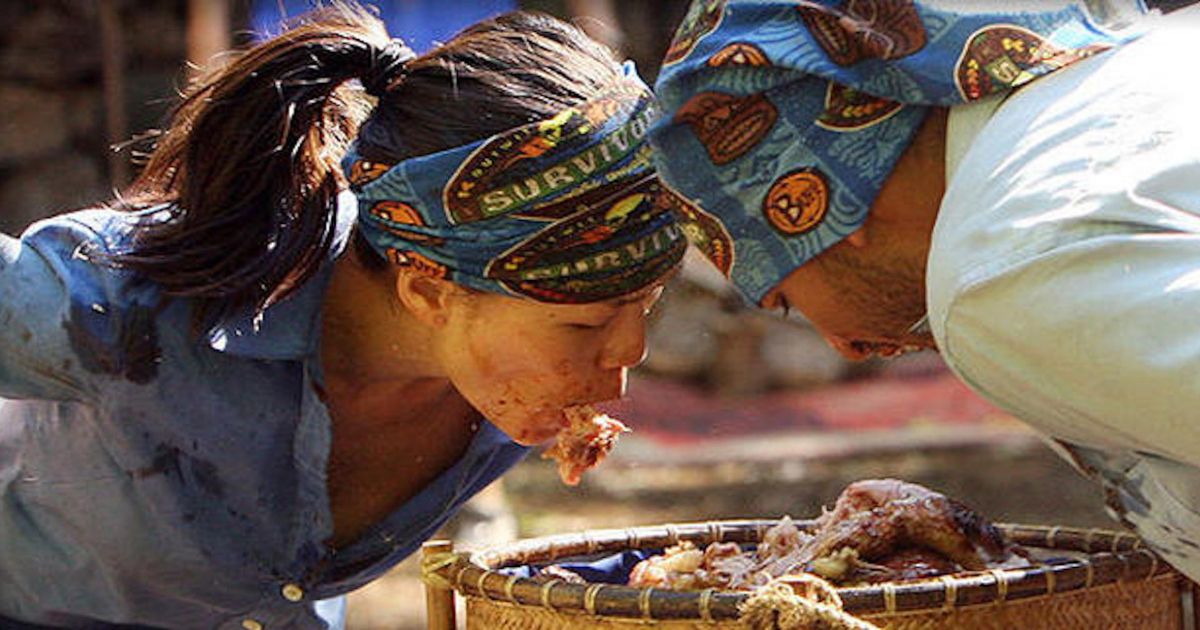 Survivor contestants use their face to dig in and eat something gross