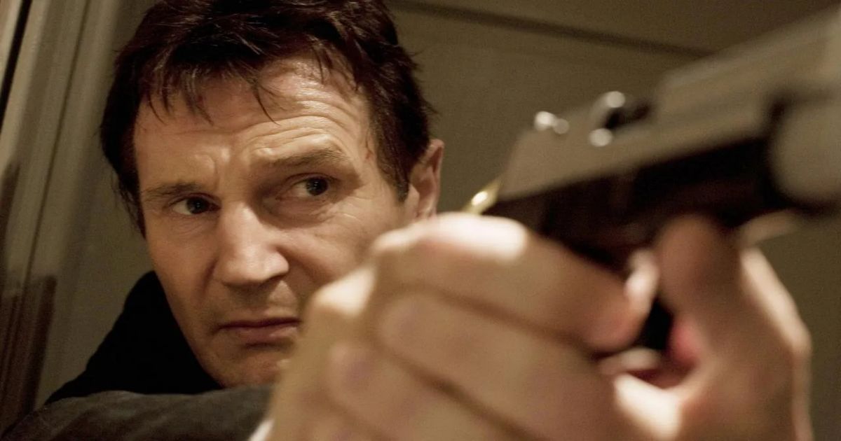 Liam Neeson points a gun in Taken