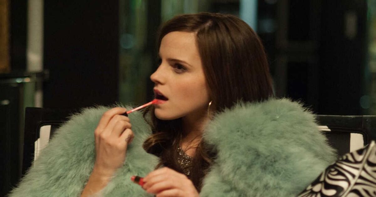 Watson in fur coat putting on lipstick in The Bling Ring