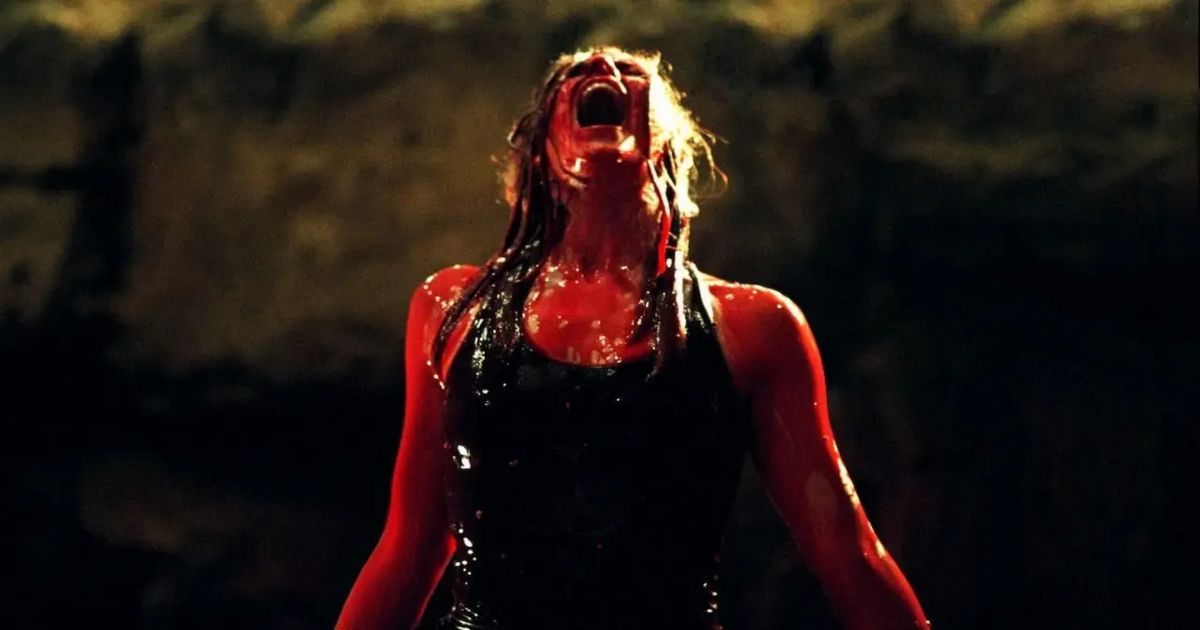 A woman covered in blood screams in The Descent 2005