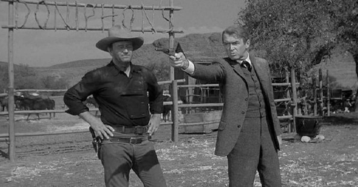 Jimmy Stewart points a gun alongside John Wayne in The Man Who Shot Liberty Valence