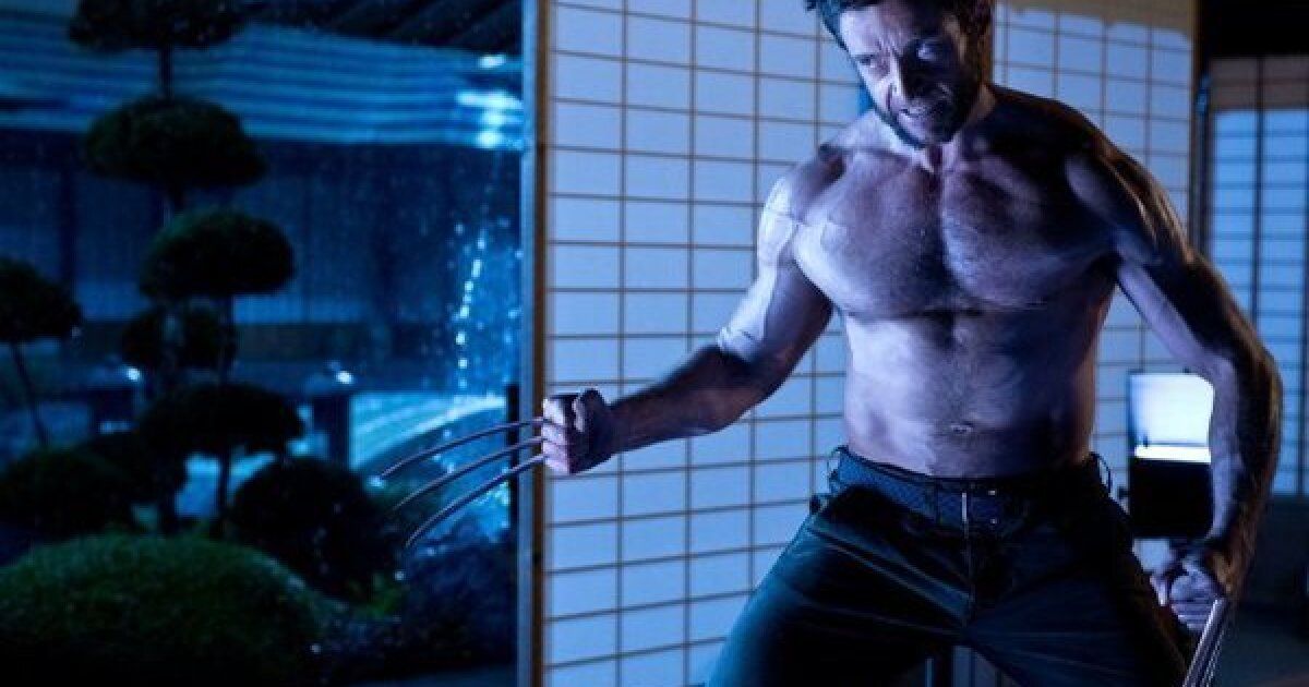 The Wolverine flexing in the blue light of Japan by a sliding panel 