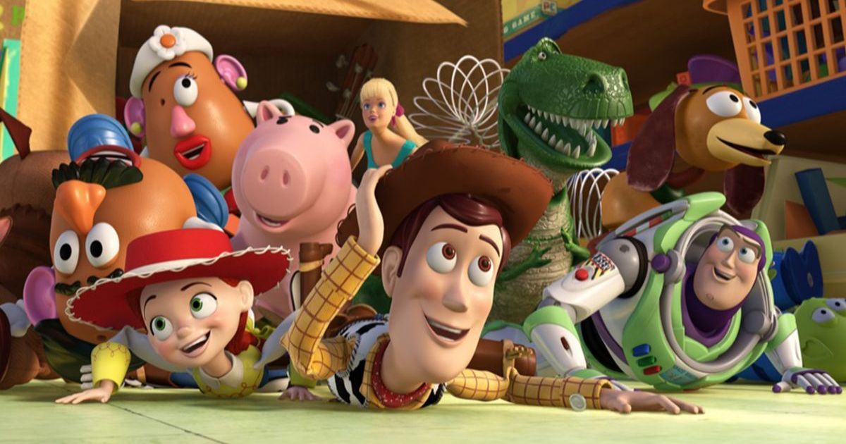 The cast huddled on the ground with Woody on the bottom in Toy Story 3