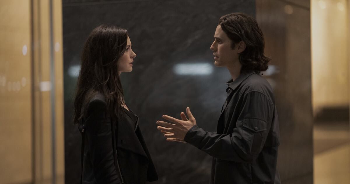WeCrashed Leto and Hathaway talk outside an elevator