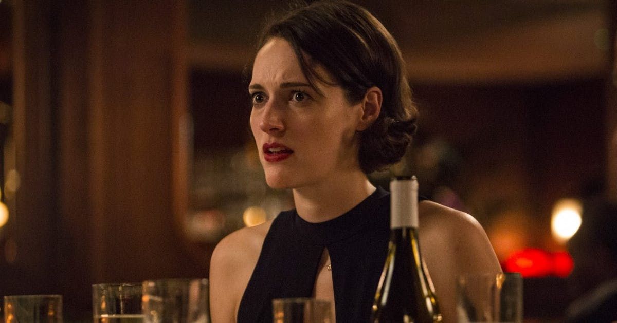 An image of Fleabag (Phoebe Waller-Bridge) sitting in the middle of a restaurant looking forlorn.