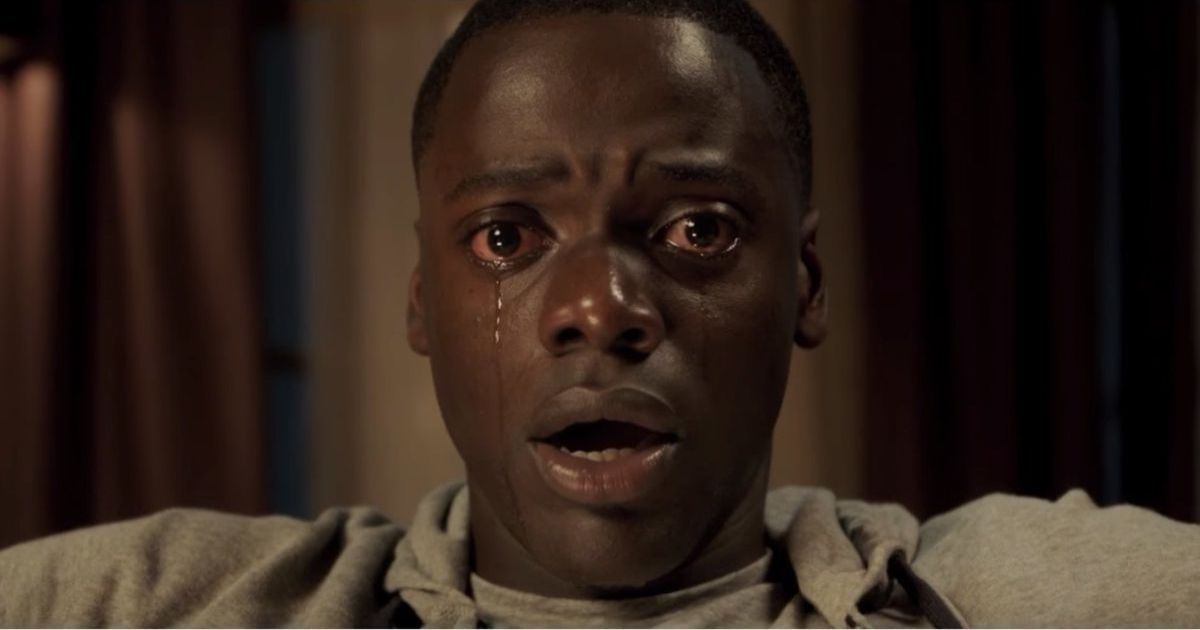 Daniel Kaluuya as Chris Washington in Get Out, tears streaming down his face as he stares in horror.