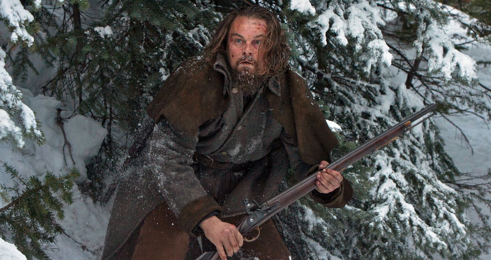 in the revenant, leonardo dicaprio stands in the icy cold with a gun