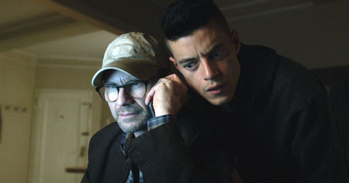 An image of Mr. Robot (Christian Slater) on a phone call, while Elliot Alderson (Rami Malek) listens in next to him. 