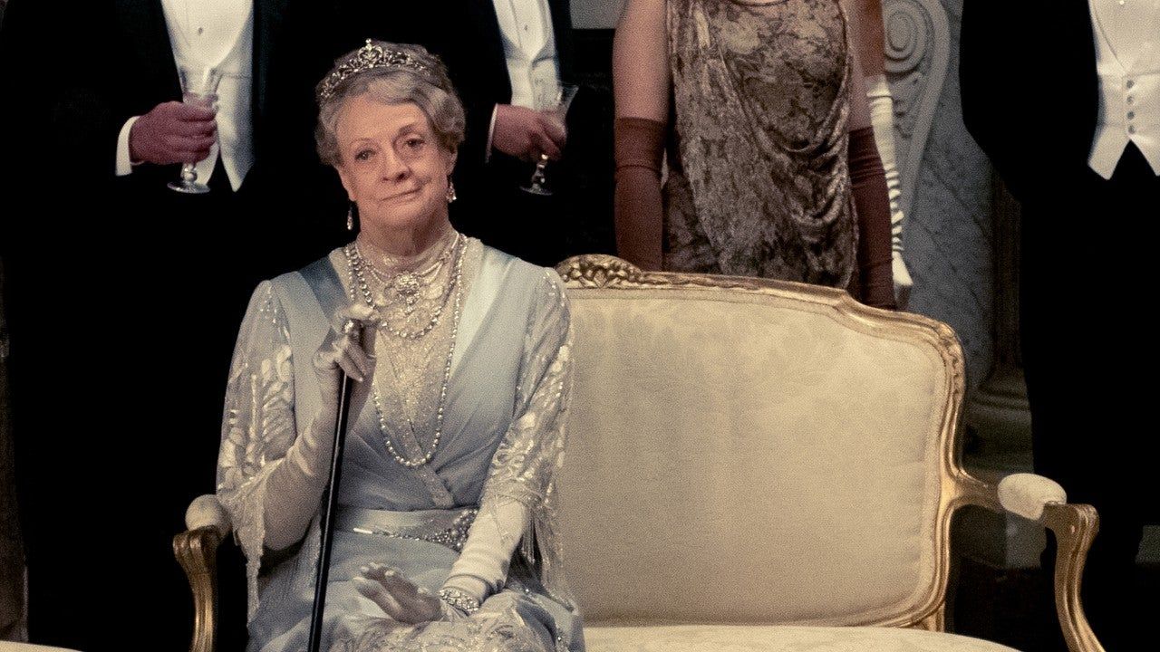 Maggie Smith sits at a house party in Downton Abbey