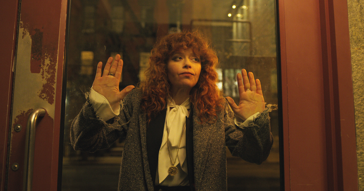 Nadia (Natasha Lyonne) puts her hands against a glass door in Russian Doll