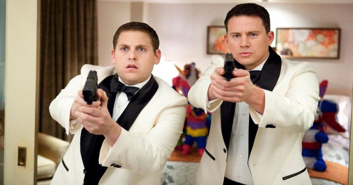 Jonah Hill and Channing Tatum point guns in white tuxedos in 21 Jump Street
