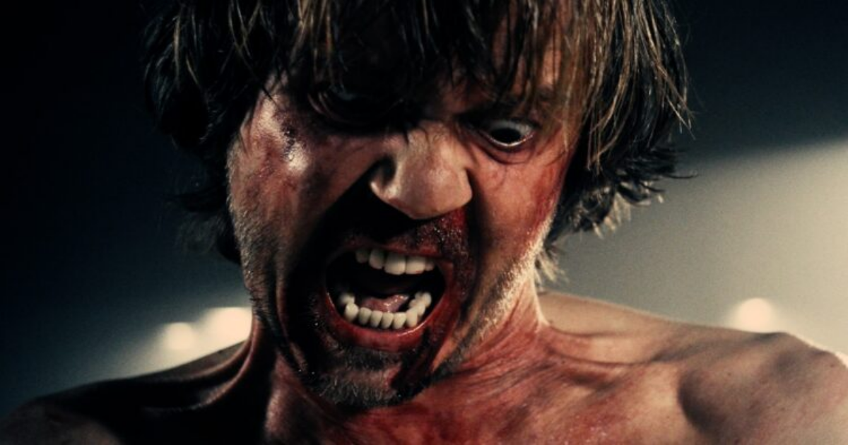 Close-up of Milo's face covered in blood while he screams in A Serbian Film