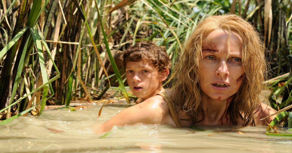The Impossible star Naomi Watts wades through the water with her son