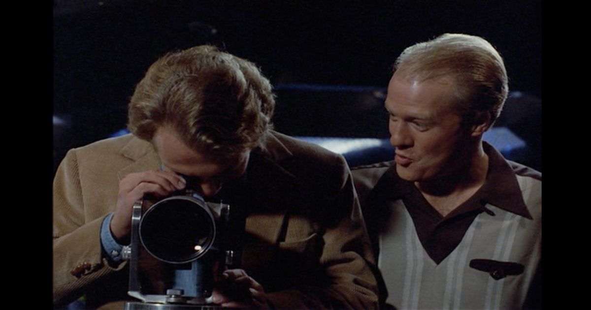 Man using telescope pointed at camera in Body Double (1984)
