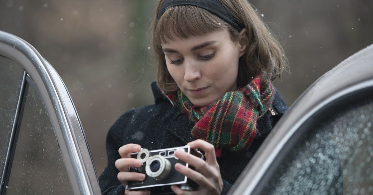 Rooney Mara as Therese Belivet holds a camera in Carol 