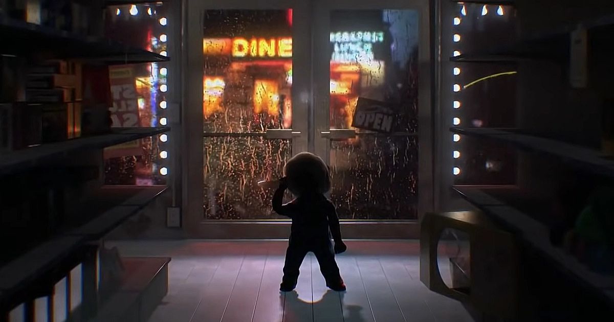 Chucky standing in a dark store by the door with a knife