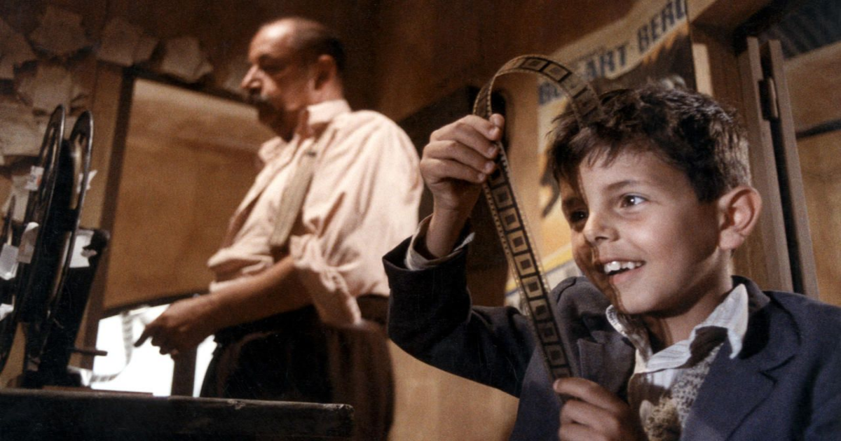 Salvatore Cascio looks at the film negative in the projection booth of a movie theatre in Cinema Paradiso