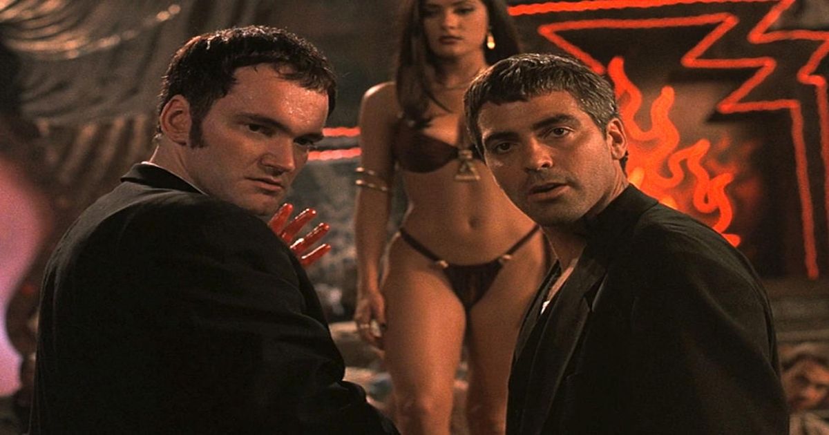 Quentin Tarantino and George Clooney stand in front of Salma Hayek in From Dusk Till Dawn