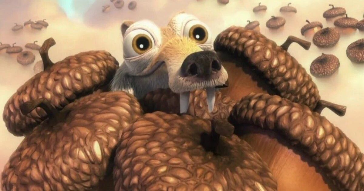 An image of Scrat from Ice Age holding an armful of acorns. 