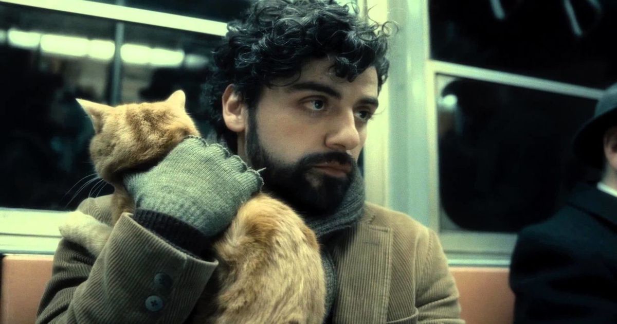 Oscar Isaac holding a cat in Inside Llewyn Davis. 