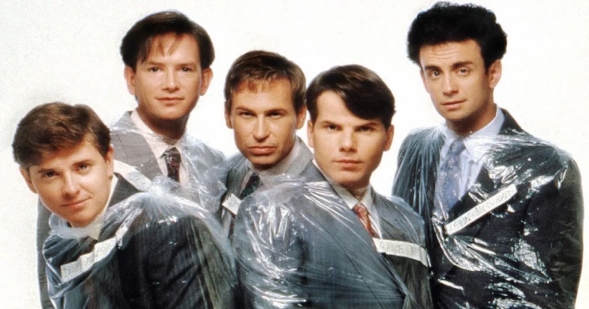 Kids in the Hall cast in dry cleaner plastic wrapped suits.