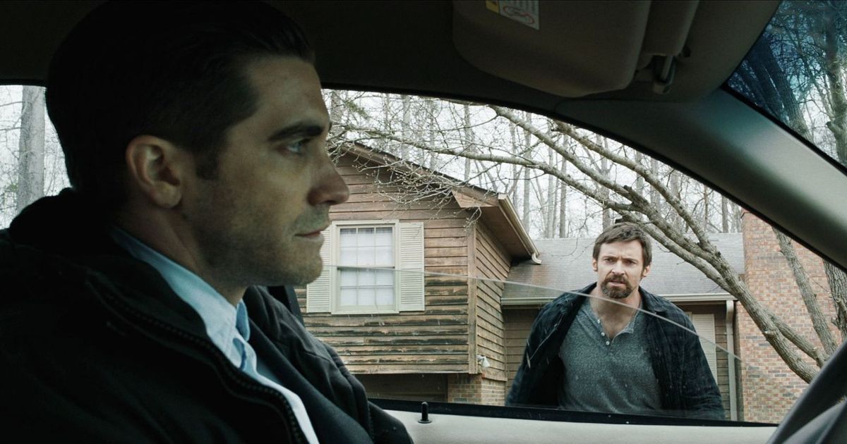 Jake Gyllenhaal in a car talking to Hugh Jackman in Prisoners.
