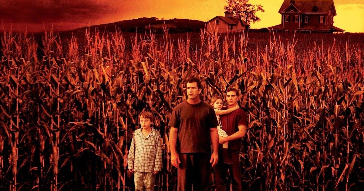 Family stands in red cornfield in the Shyamalan movie Signs