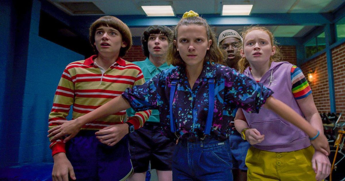 The young cast of Stranger Things in a hallway