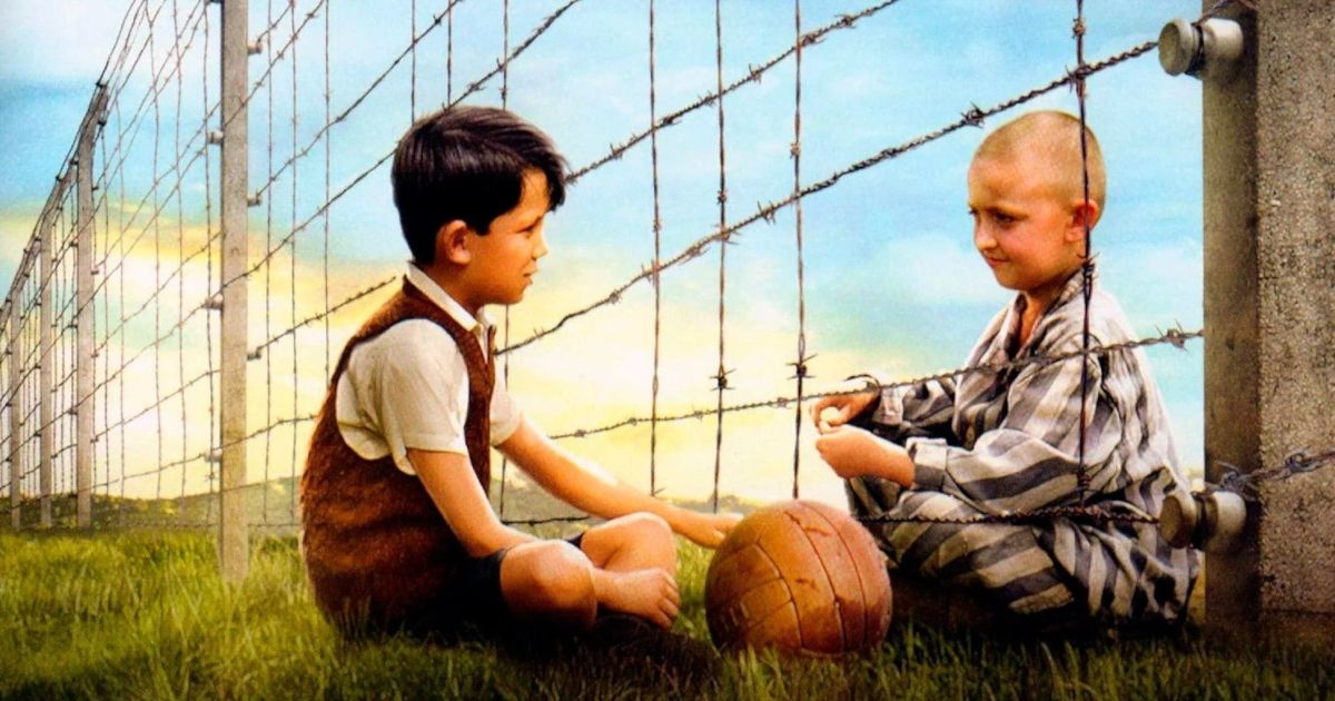 A boy sits across a concentration camp prisoner in The Boy in the Striped Pajamas