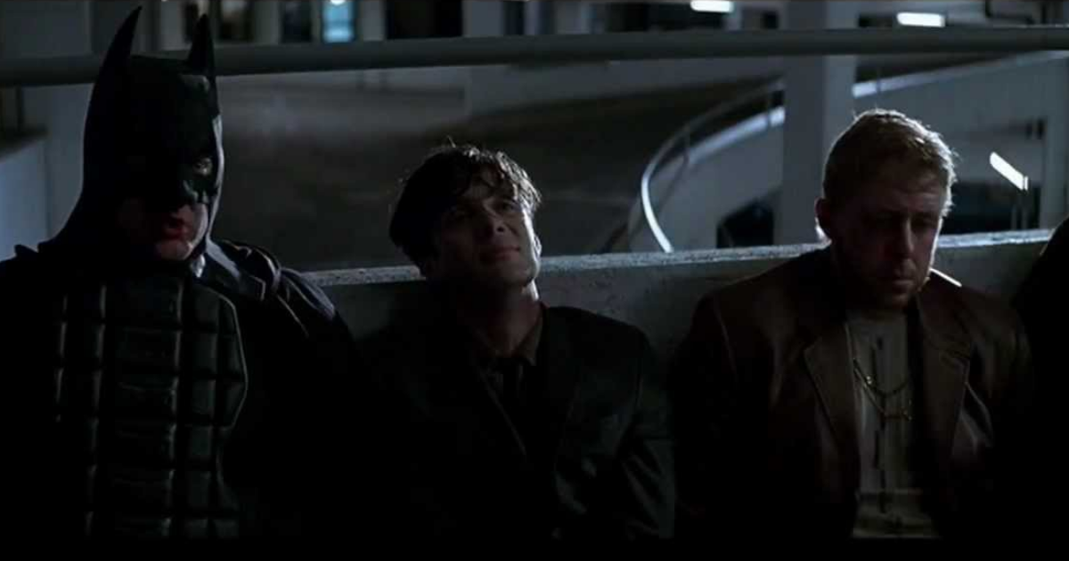 Cillian Murphy in a line-up of arrested people in a parking garage in The Dark Knight