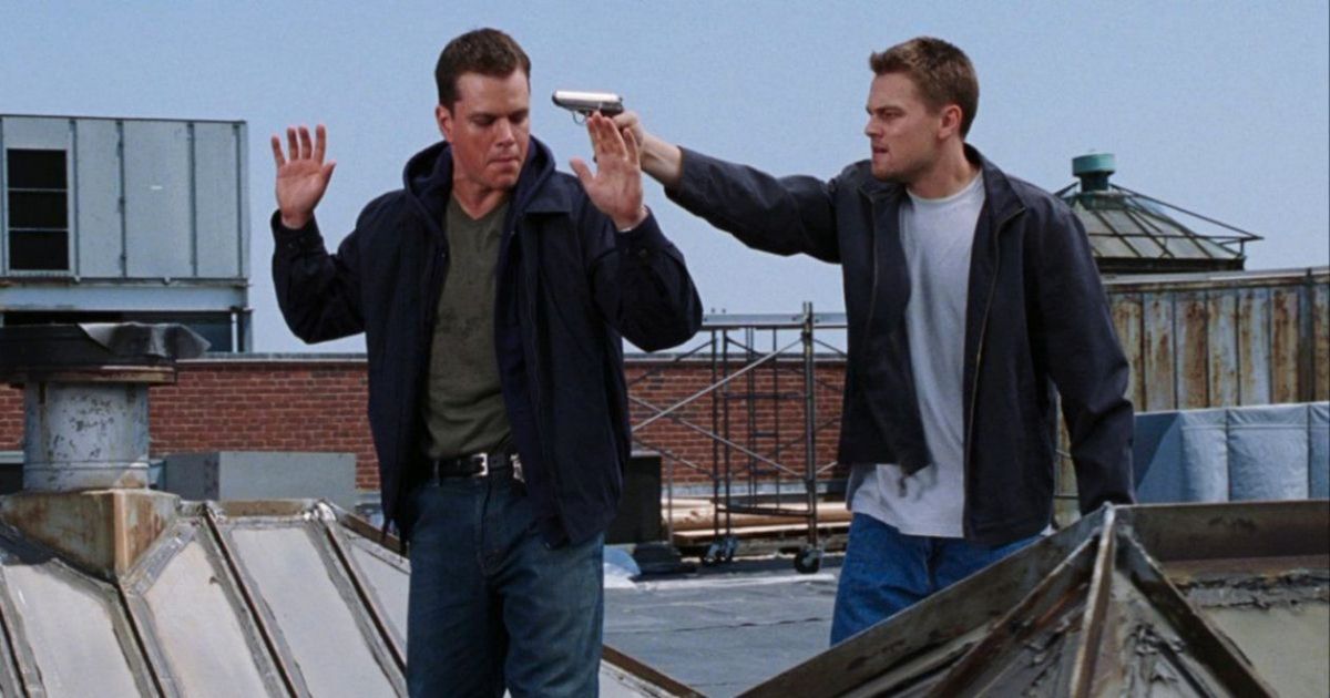 DiCaprio points a gun at Matt Damon on the roof in The Departed 