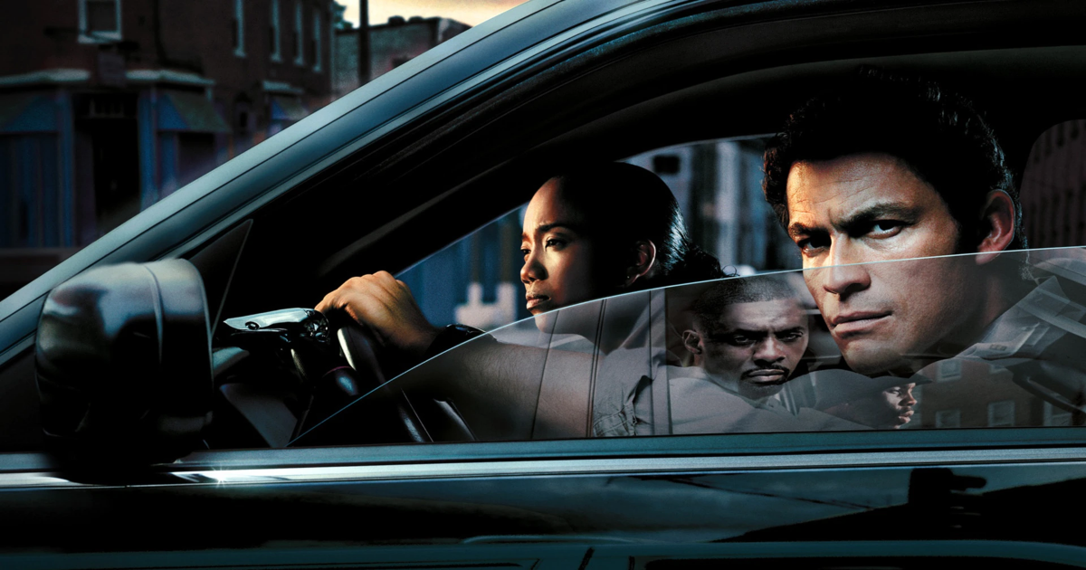 McNulty and other cops in the car as a drug dealer is reflected in the car window in The Wire 