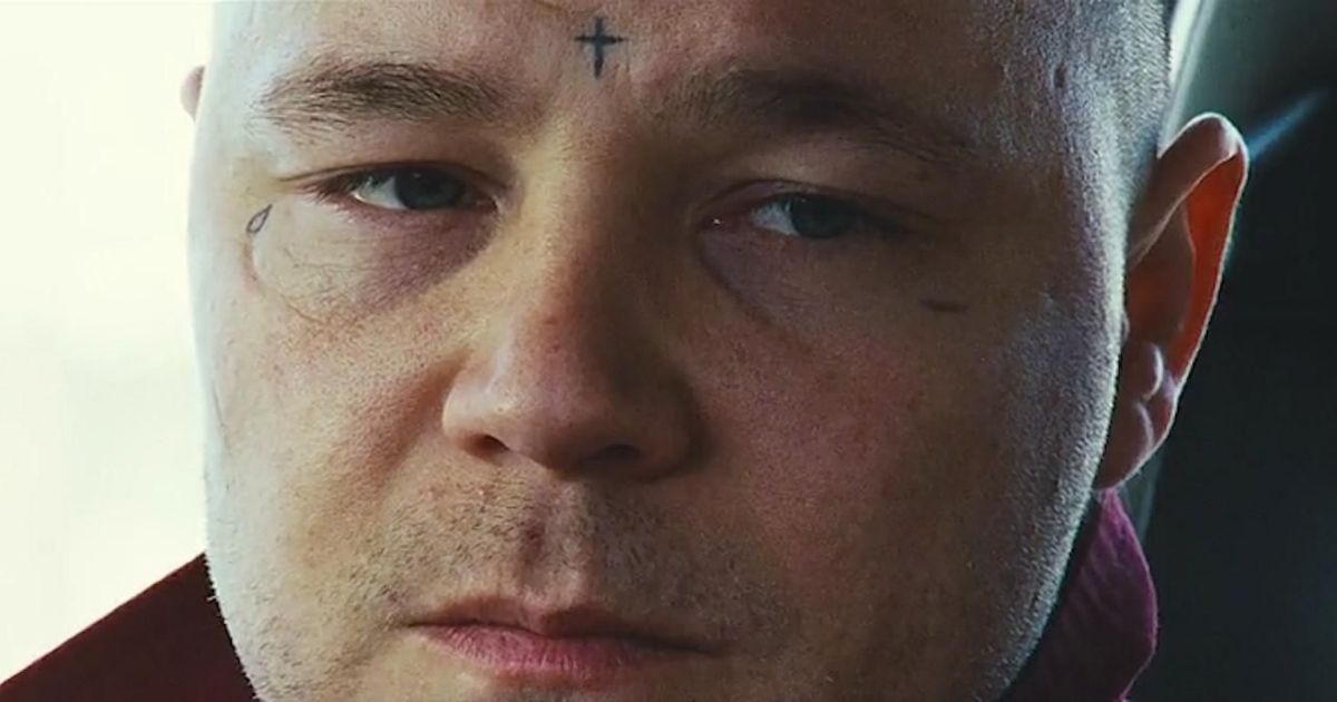 Stephen Graham's face with a cross on his forehead in This is England