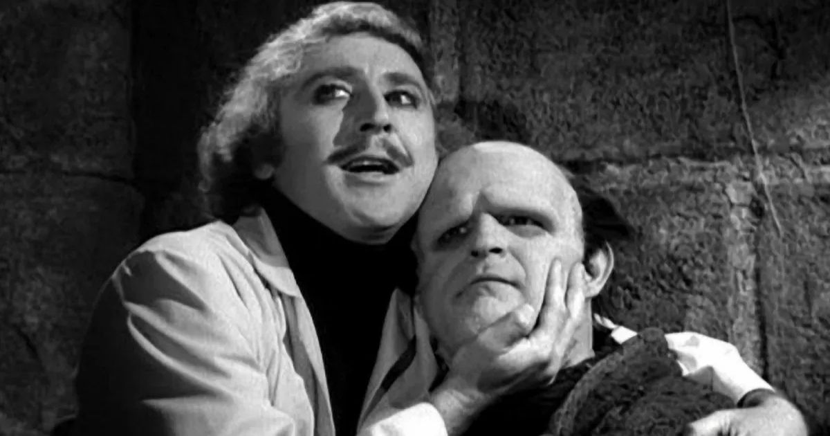 Gene Wilder's Frankenstein holds his monster's chin