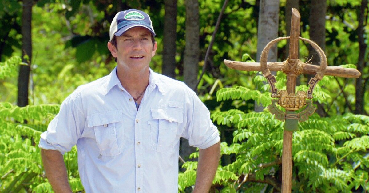 Jeff Probst on Survivor with an immunity necklace next to him.