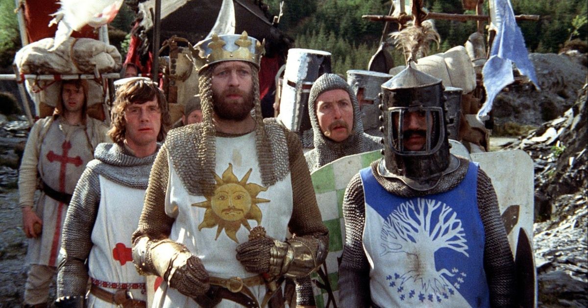 A group of knights in various armors, all looking at something with confused faces.