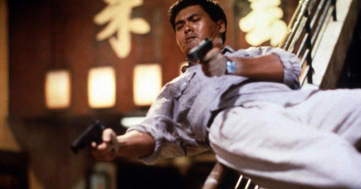 Chow Yun-Fat slides down stairs with guns in Hard Boiled