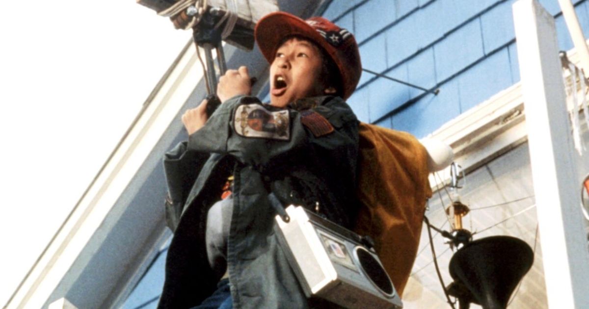 Ke Huy Quan as data in The Goonies riding on a zip wire.