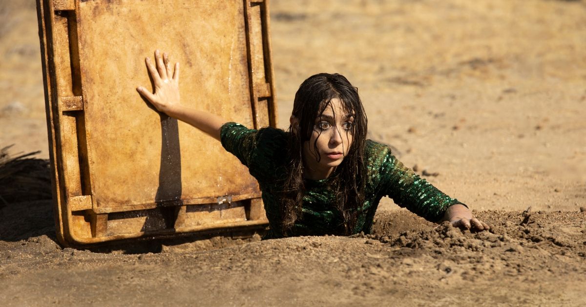 Cristin Milioti climbing out of a underground shelter in Made For Love
