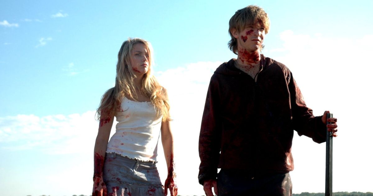 Mandy and Emmet standing together, covered in blood.