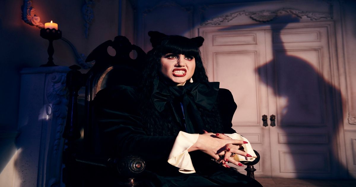 Nadja sits in an ornate chair in What We Do in the Shadows