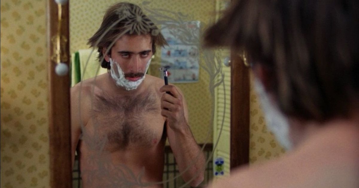 H.I. "Hi" McDonough (Nicolas Cage) shirtless and shaving his beard in apparent contempt, Raising Arizona. 