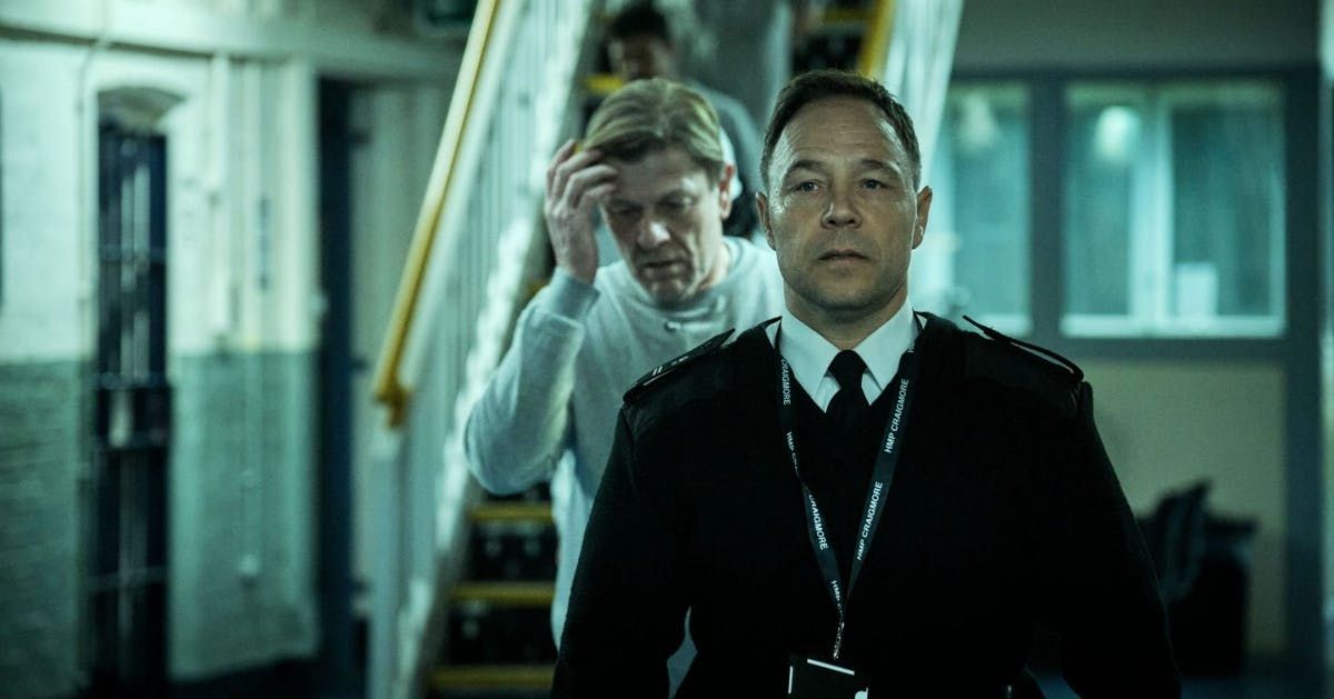 Stephen Graham as an officer leading Sean Bean through prison in Time
